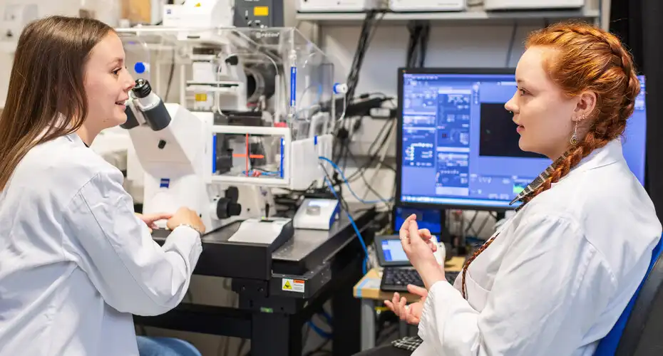 Two students in discussion in the lab