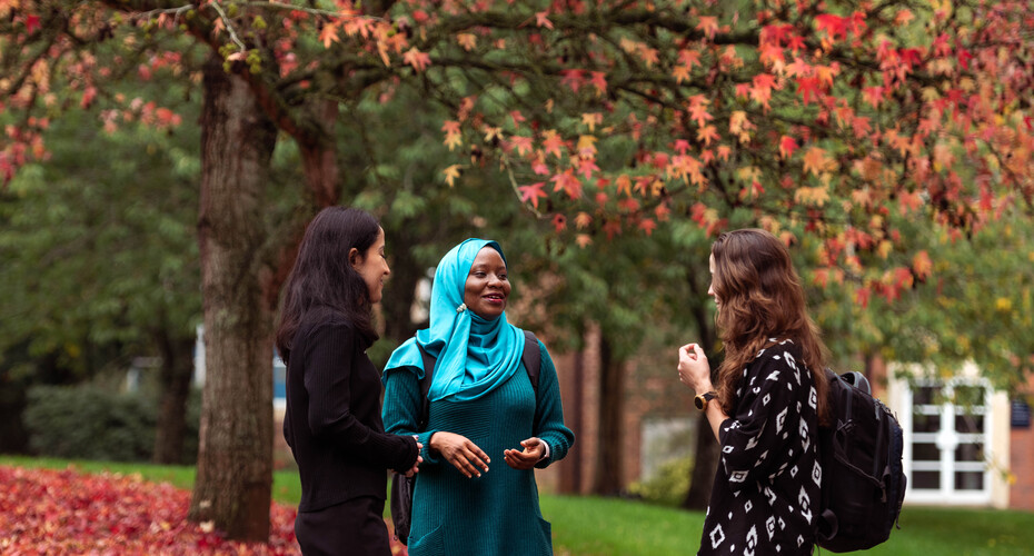 Three students talking together in the grounds on St Luke's Campus