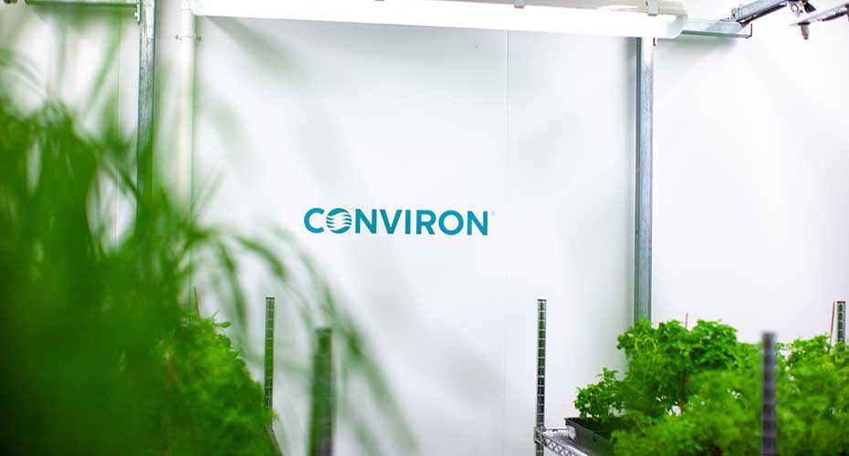 Inside the GMS facility showing plants and Conviron logo